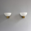 A pair of French Art Deco Bronze and White Glass Sconces by Jean Perzel