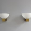 A pair of French Art Deco Bronze and White Glass Sconces by Jean Perzel